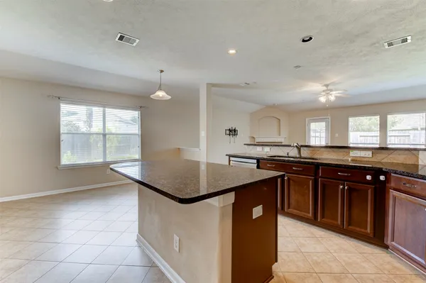 a kitchen with a sink window and cabinets