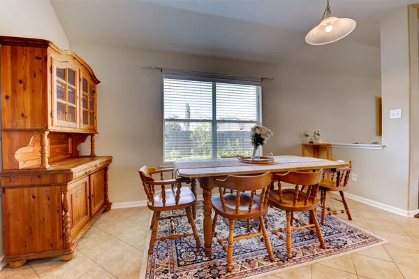 a dining room with furniture window and wooden floor