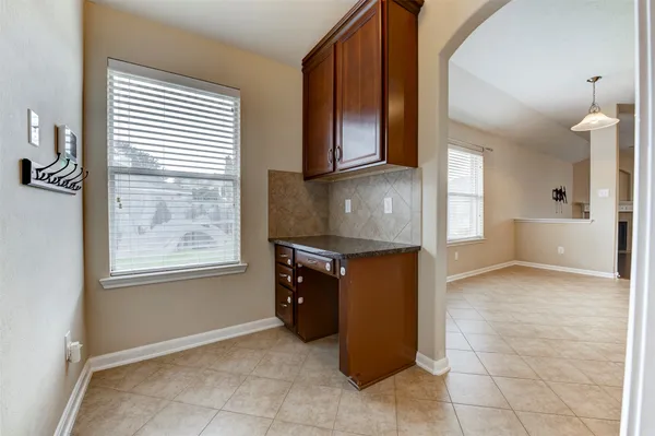 a kitchen with stainless steel appliances granite countertop a refrigerator and a stove