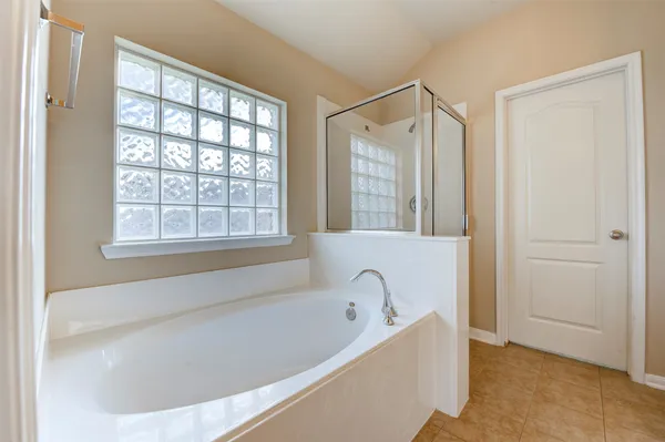a bathroom with a bathtub and shower