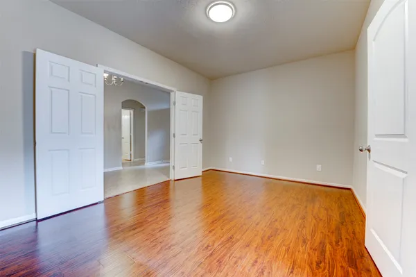 a view of an empty room and wooden floor