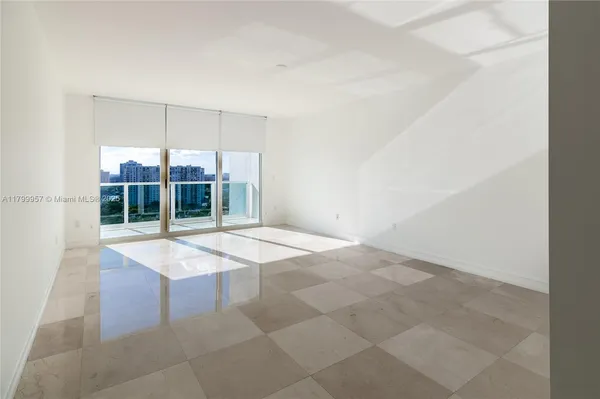 a large bedroom with a bed and a view of bathroom