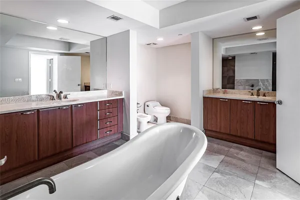 a spacious bathroom with a bathtub and shower