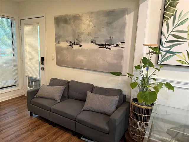 a view of a workspace with furniture and a flat screen tv