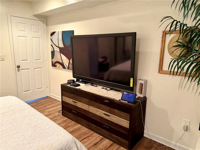 a bedroom with a large bed and a chandelier