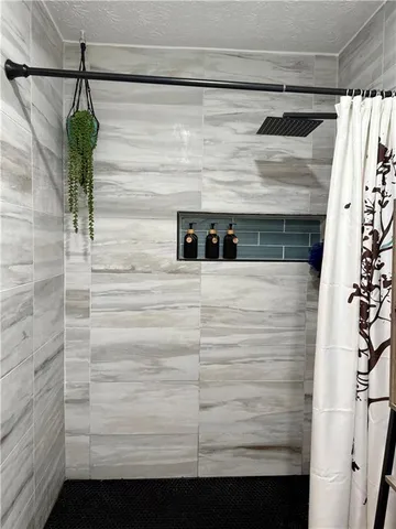 a bedroom with a bed and painting on the wall