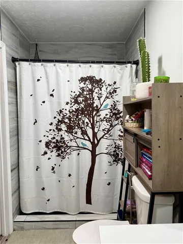 a bedroom with a bed and a potted plant