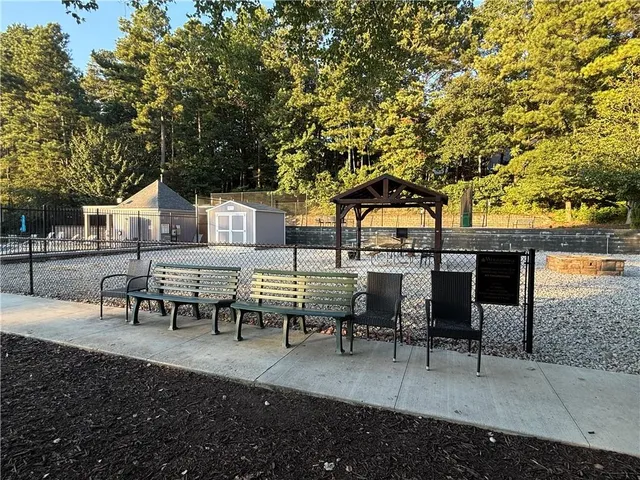 a view of a house with swimming pool and sitting area