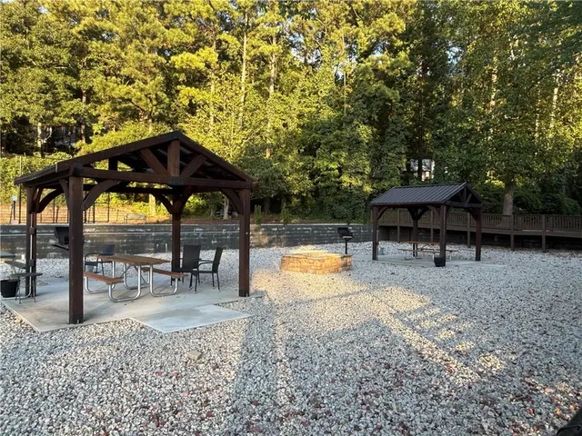 a view of a garden with cars parked