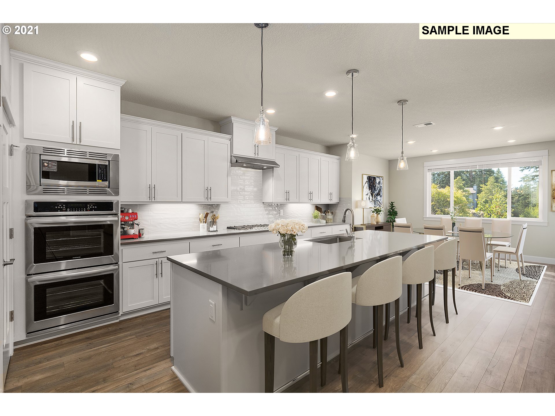 1715 Northeast Hancock Road Camas, WA 98607 - Photo 7 of 14 a kitchen with kitchen island stainless steel appliances a dining table and chairs