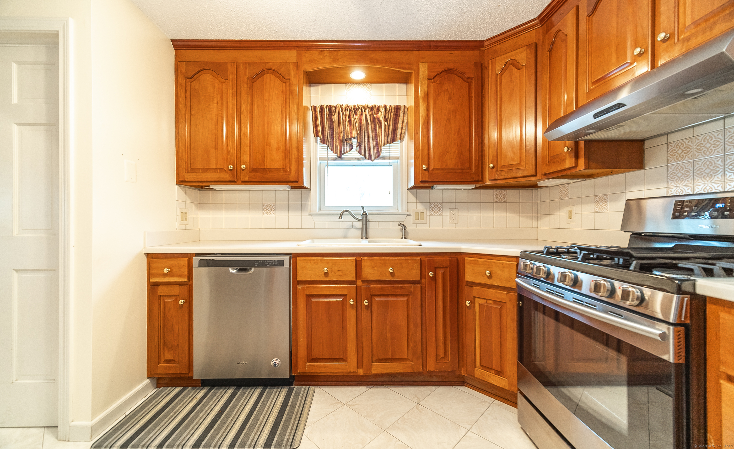 18 Ingram Street Hamden, CT 06517 - Photo 13 of 39 a kitchen with stainless steel appliances granite countertop a stove a sink and a microwave