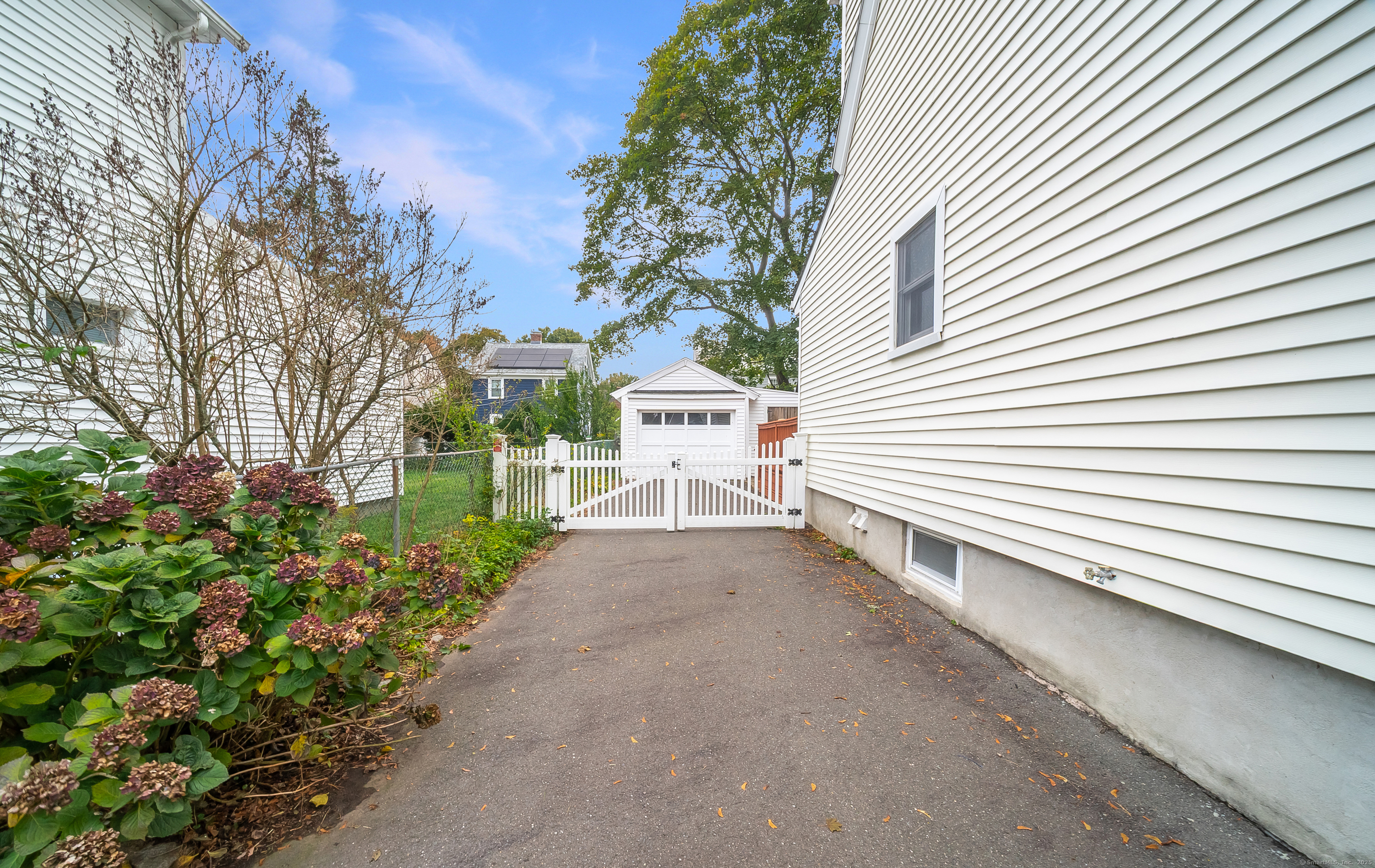 18 Ingram Street Hamden, CT 06517 - Photo 3 of 39 a view of a white house with a yard and potted plants