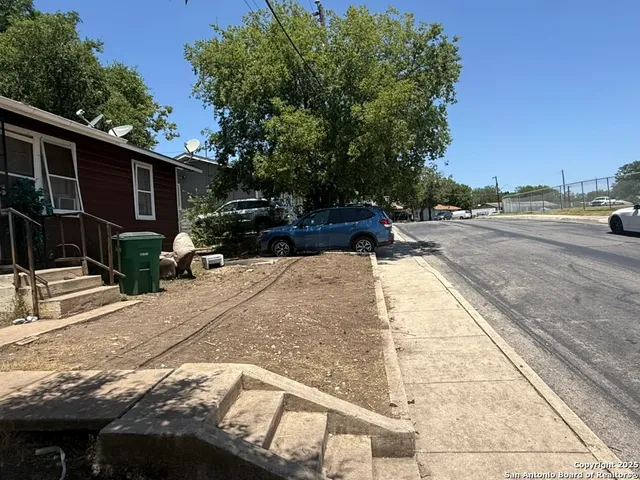a view of a backyard with sitting area