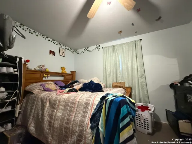 a bed sitting in a bedroom next to a window
