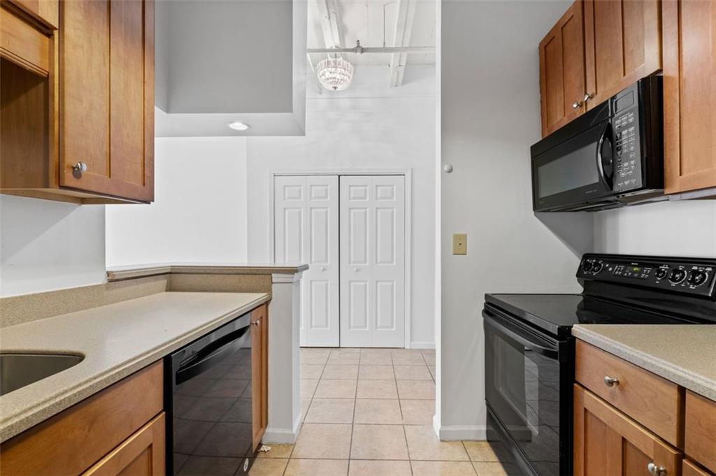 32 Peachtree Street Northwest, Unit 804 Atlanta, GA 30303 - Photo 11 of 40 a kitchen with granite countertop a stove sink and microwave