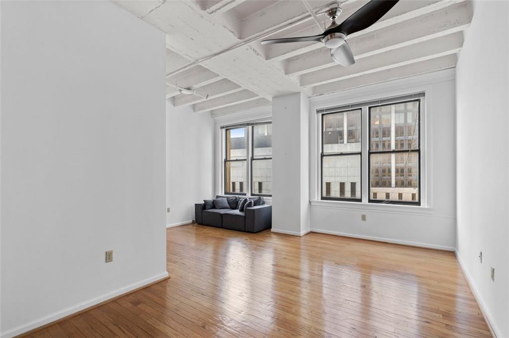 32 Peachtree Street Northwest, Unit 804 Atlanta, GA 30303 - Photo 13 of 40 an empty room with wooden floor and windows