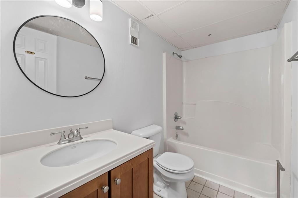 32 Peachtree Street Northwest, Unit 804 Atlanta, GA 30303 - Photo 24 of 40 a bathroom with a sink toilet and a mirror