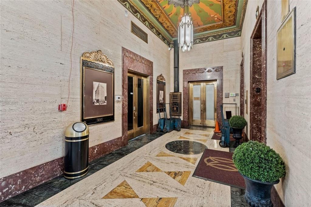 32 Peachtree Street Northwest, Unit 804 Atlanta, GA 30303 - Photo 6 of 40 a bathroom with a granite countertop sink a mirror and shower