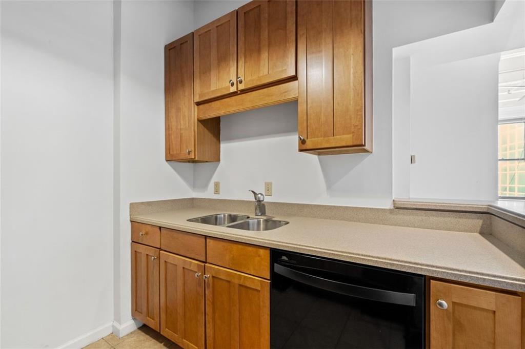 32 Peachtree Street Northwest, Unit 804 Atlanta, GA 30303 - Photo 10 of 40 a kitchen with stainless steel appliances granite countertop a sink and cabinets