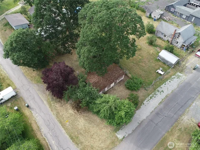an aerial view of a house with a yard