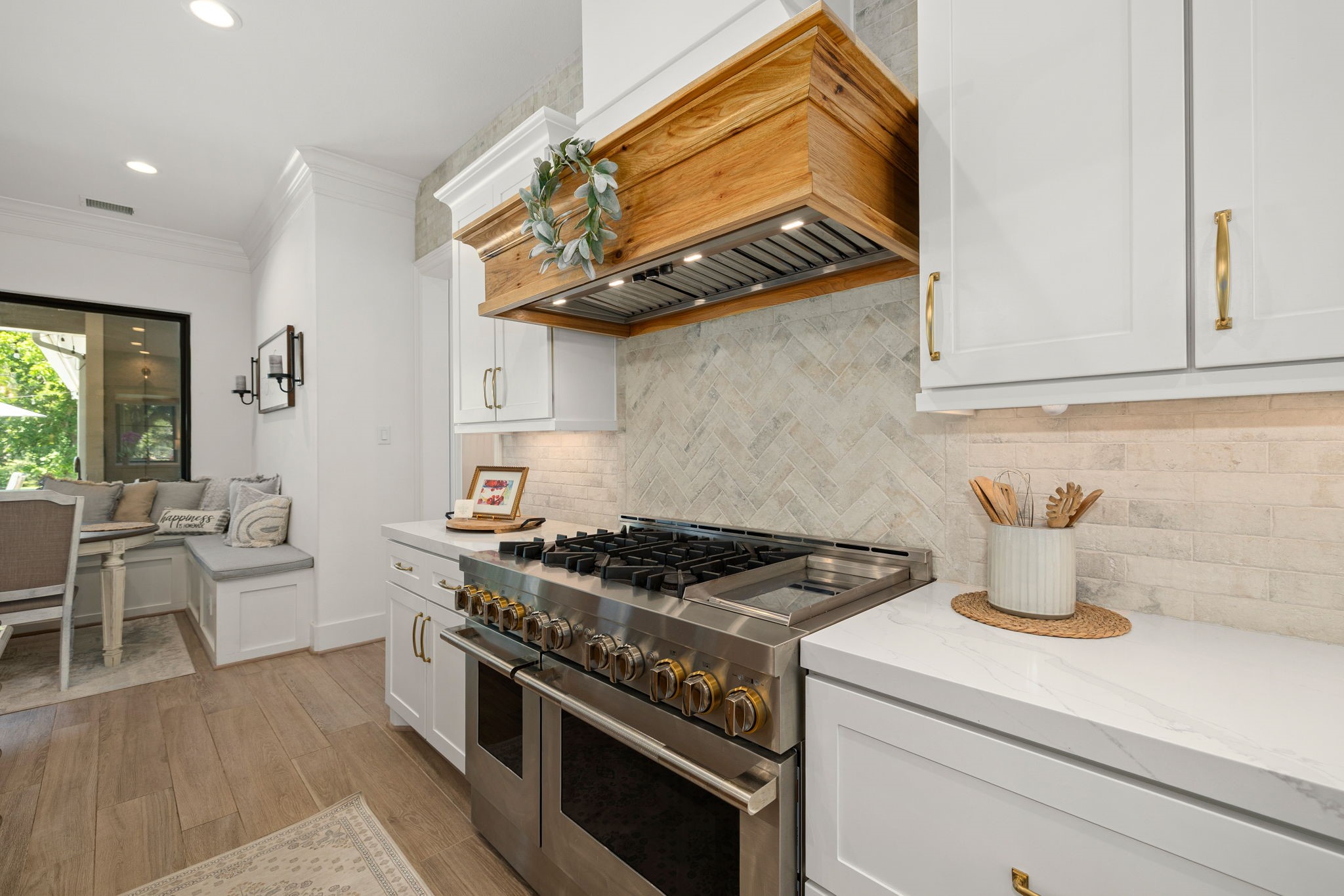 4311 Upper Oxbow Trace Fulshear, TX 77441 - Photo 13 of 49 Professional-grade gas range with custom wood vent hood.
