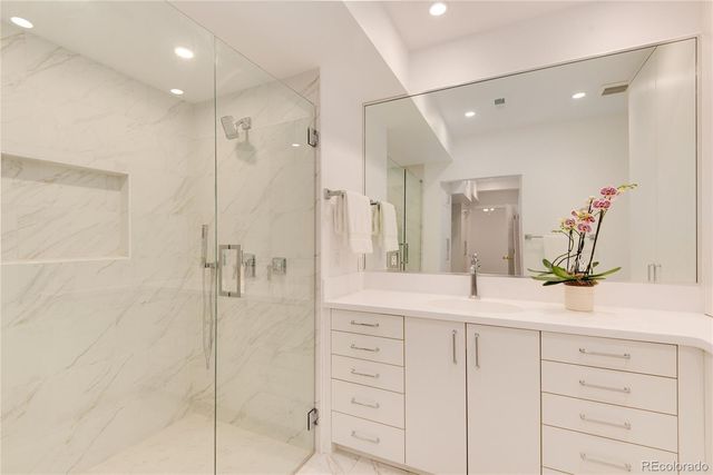 a view of a kitchen with white cabinets stainless steel appliances
