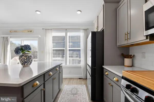 a kitchen with granite countertop a sink stove and refrigerator