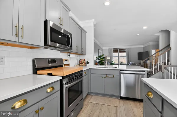a kitchen with stainless steel appliances granite countertop a sink and stove top oven