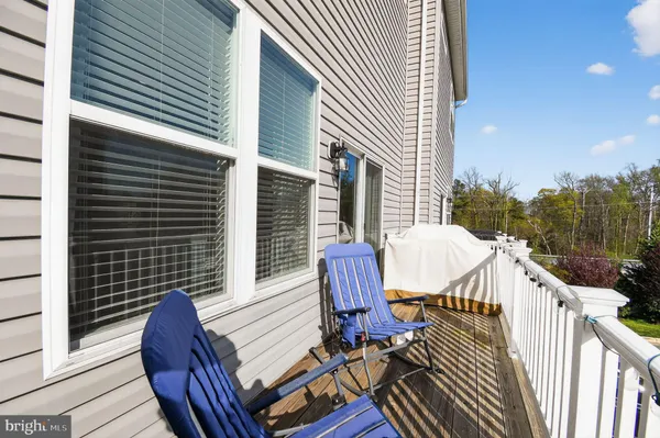 a view of balcony with wooden floor and outdoor seating