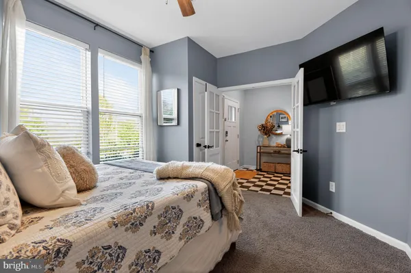 a bedroom with a bed and a flat screen tv