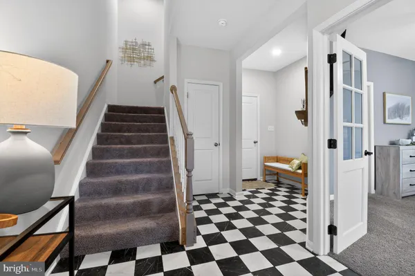 a view of a bathroom with a black and white checkered floor