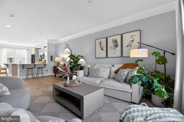 a living room with furniture flowers and a chandelier