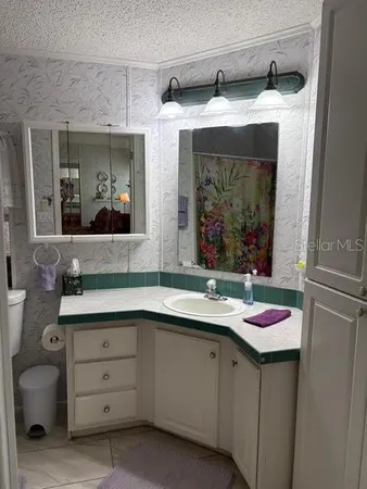 a bathroom with a sink mirror vanity and toilet