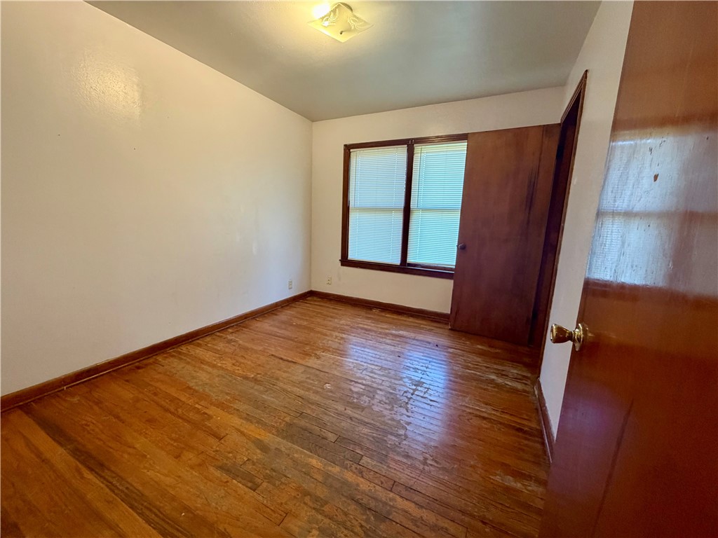 4914 Carroll Lane Corpus Christi, TX 78415 - Photo 3 of 10 an empty room with wooden floor and windows