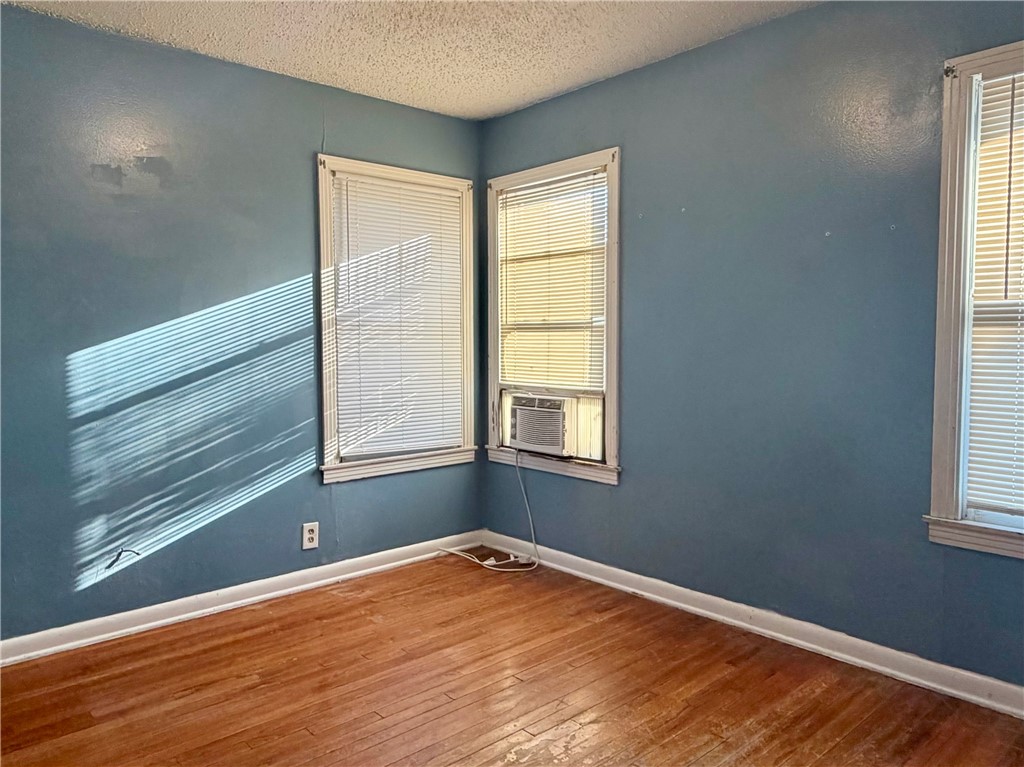 4914 Carroll Lane Corpus Christi, TX 78415 - Photo 5 of 10 a view of an empty room with wooden floor and a window