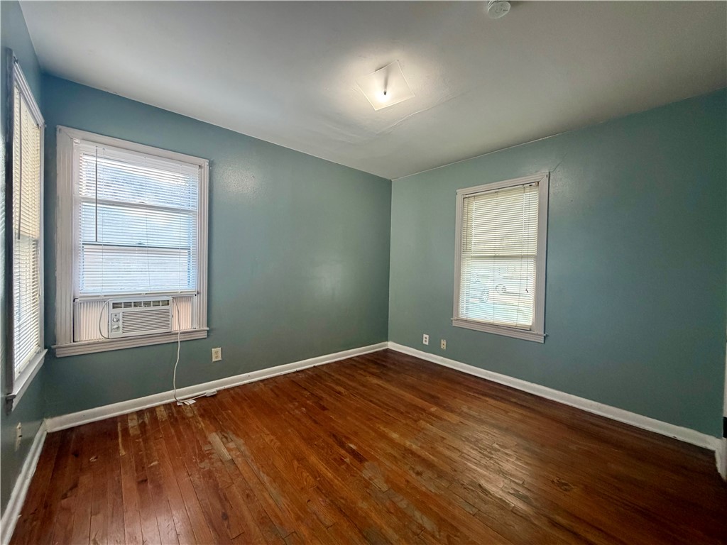 4914 Carroll Lane Corpus Christi, TX 78415 - Photo 6 of 10 an empty room with wooden floor and windows