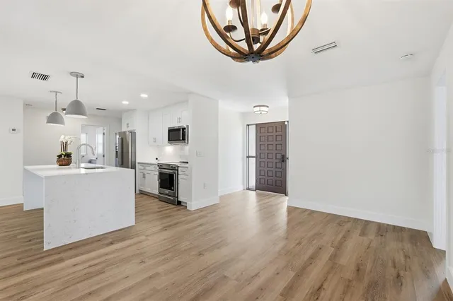 a kitchen with granite countertop a stove and a microwave