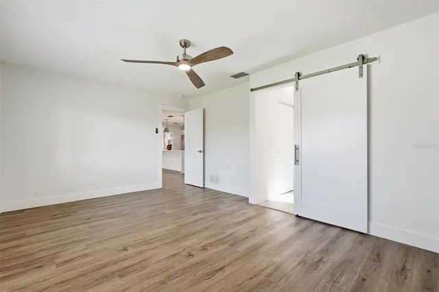 a bathroom with a granite countertop toilet a sink and mirror