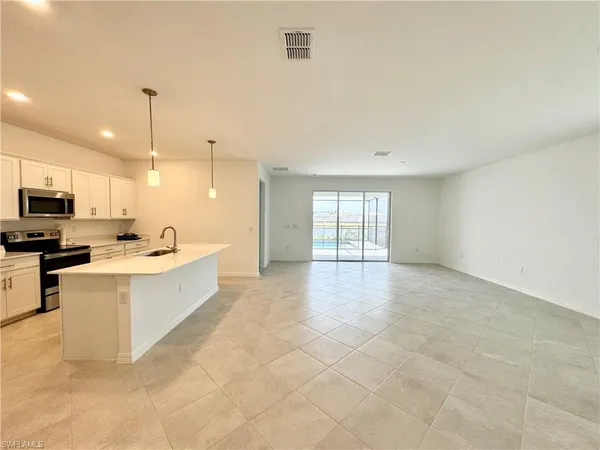 a large white kitchen with a large window