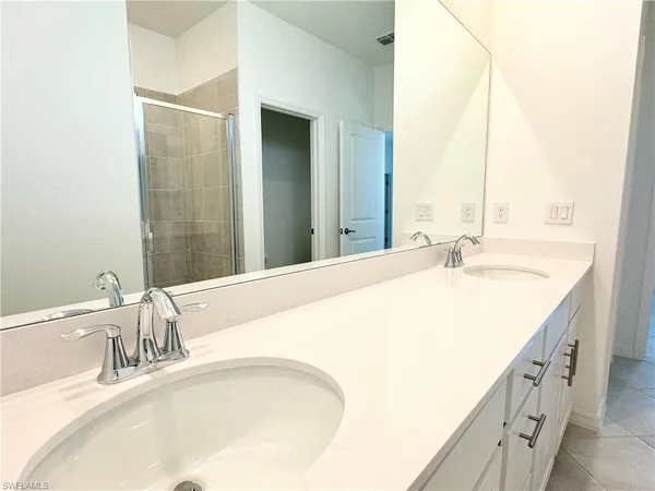 a bathroom with a granite countertop sink and a large mirror