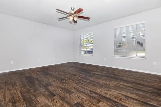 wooden floor in an empty room with a window