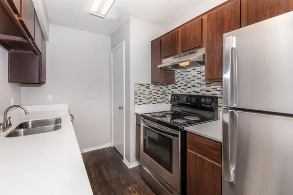 a kitchen with a stove and a refrigerator