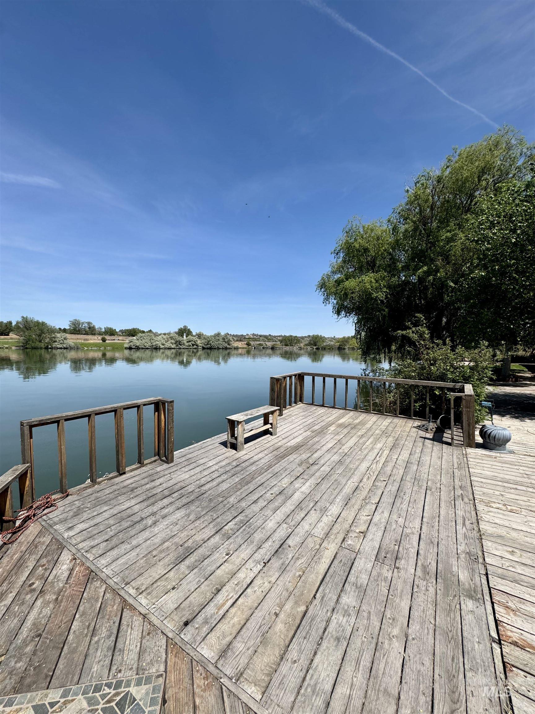 62 Bell Rapids Road Hagerman, ID 83332 - Photo 6 of 34 Expansive waterfront deck featuring wood planking and a wooden railing