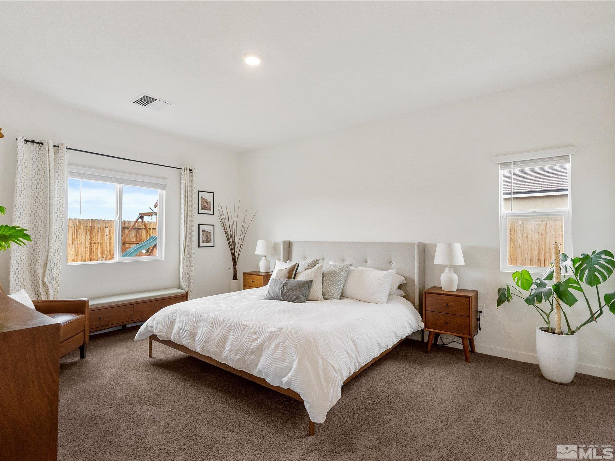 1173 Alder Drive Fallon, NV 89406 - Photo 16 of 40 a bedroom with a bed and potted plant