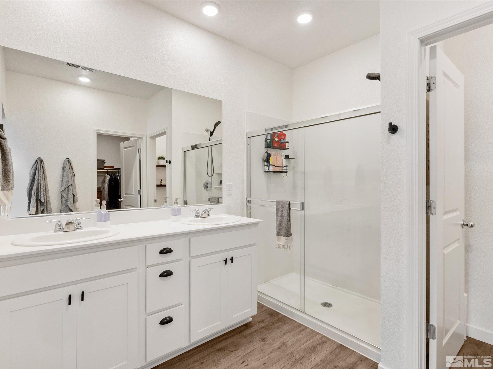 1173 Alder Drive Fallon, NV 89406 - Photo 22 of 40 a bathroom with a shower sink and mirror