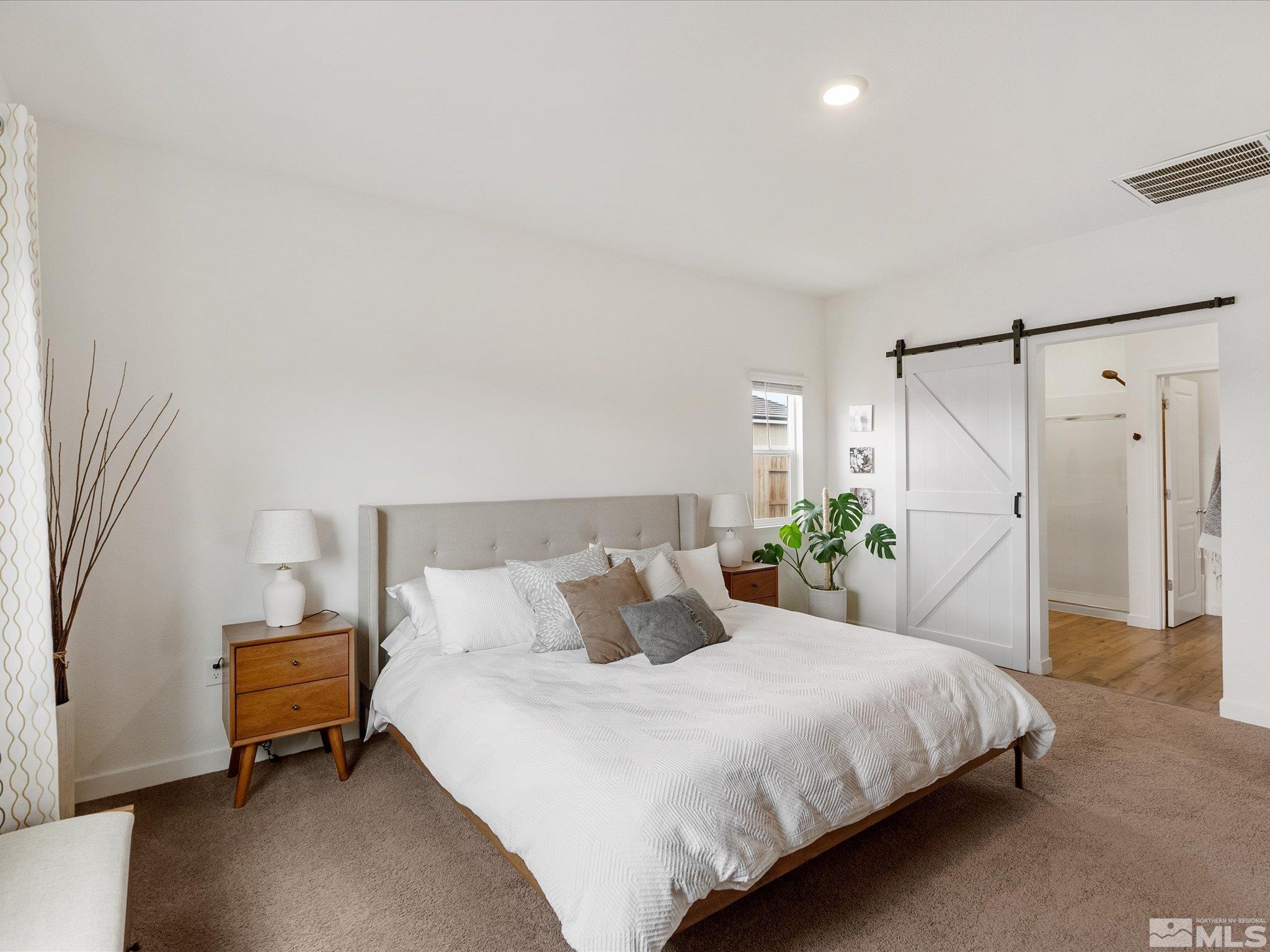 1173 Alder Drive Fallon, NV 89406 - Photo 23 of 40 a bedroom with a bed and a potted plant