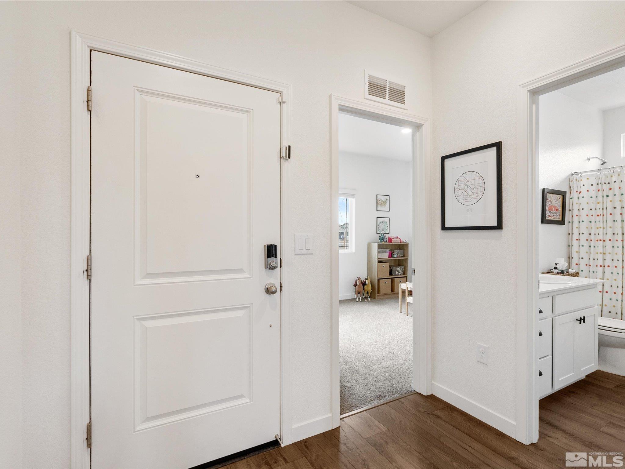 1173 Alder Drive Fallon, NV 89406 - Photo 24 of 40 a view of a hallway to closet with wooden floor
