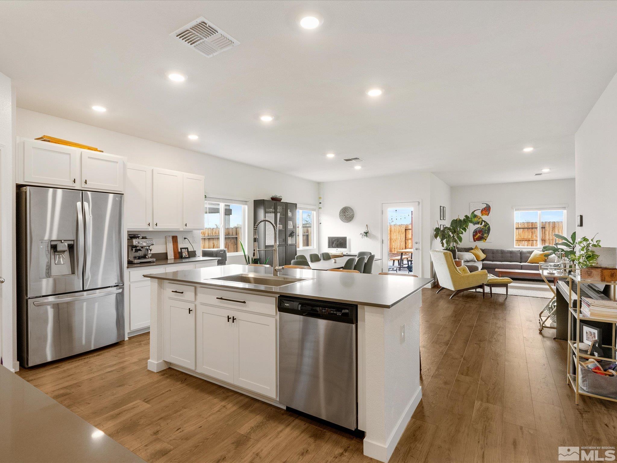 1173 Alder Drive Fallon, NV 89406 - Photo 5 of 40 a kitchen with sink refrigerator and cabinets
