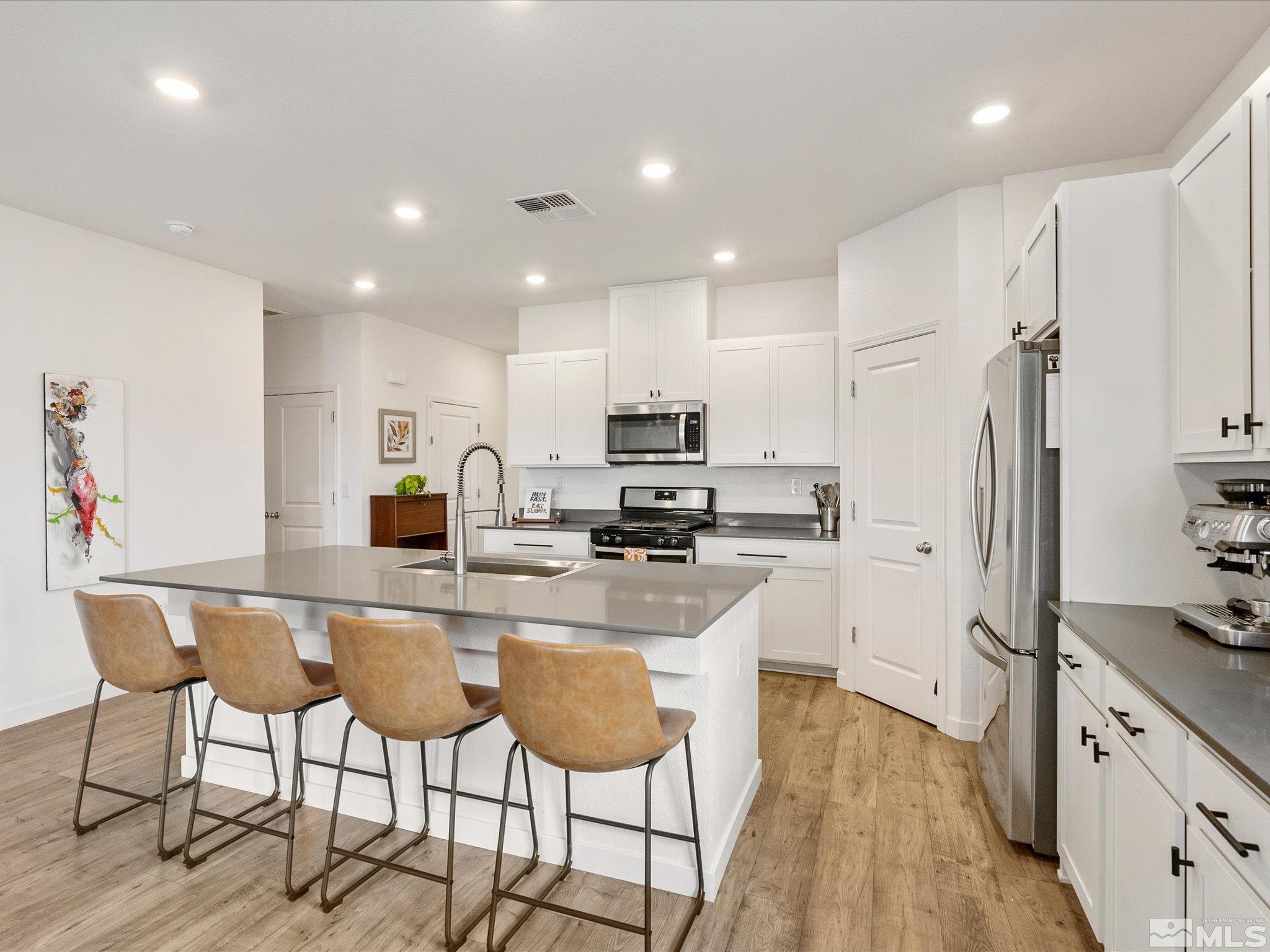 1173 Alder Drive Fallon, NV 89406 - Photo 8 of 40 a kitchen with stainless steel appliances granite countertop a refrigerator and a stove top oven