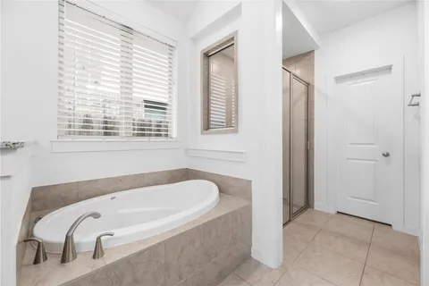 a spacious bathroom with a granite countertop double vanity sink mirror and bathtub